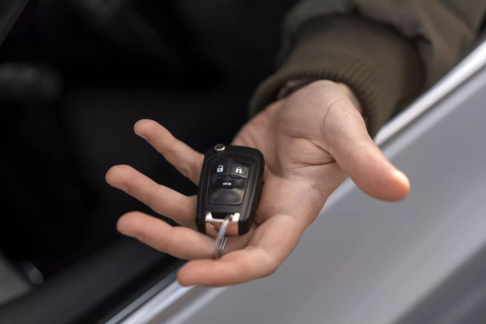 Handing a Car Key - Call a Locksmith